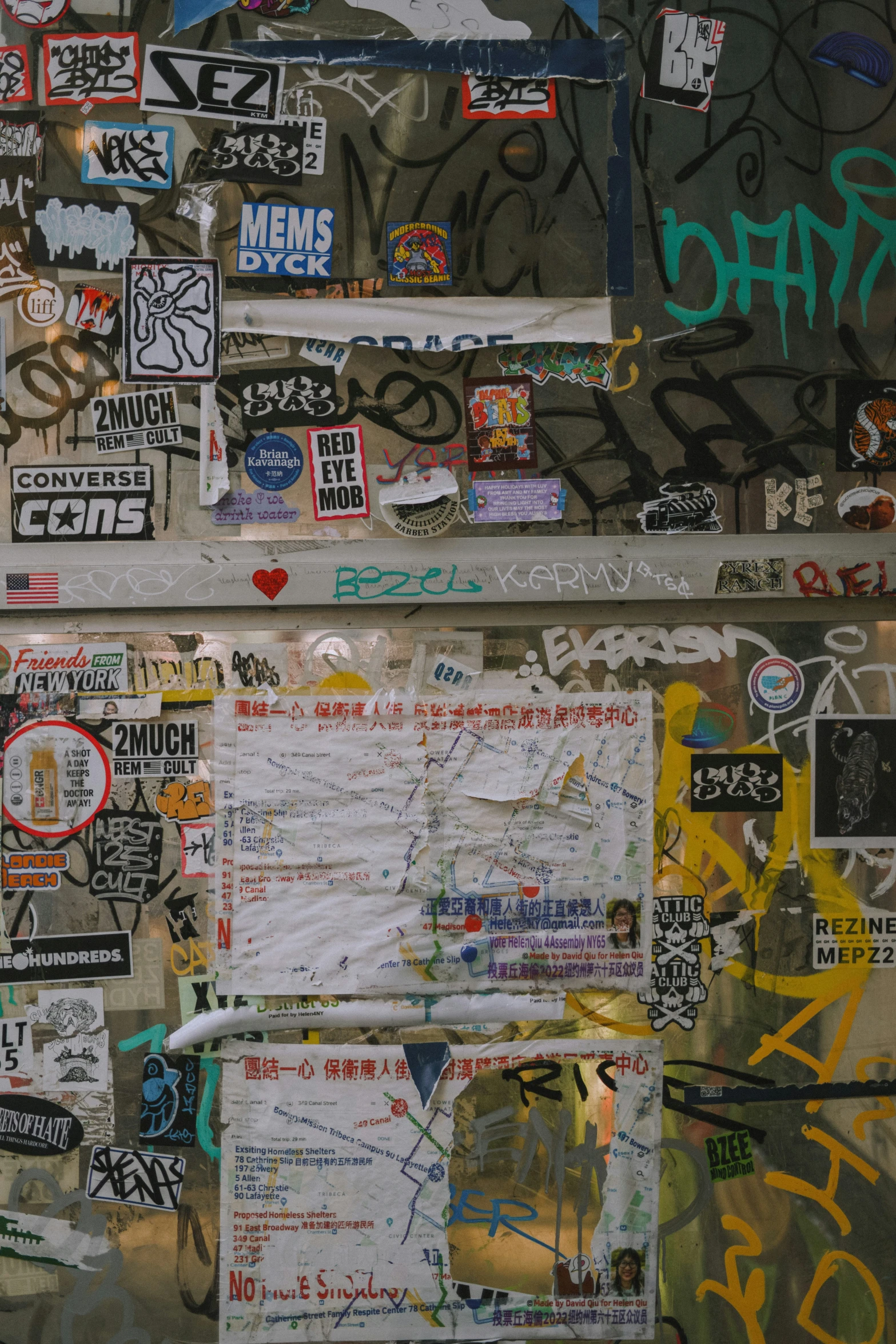 multiple pographs and graffiti on a wall