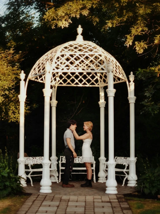 a couple in love looking into each others eyes underneath a canopy