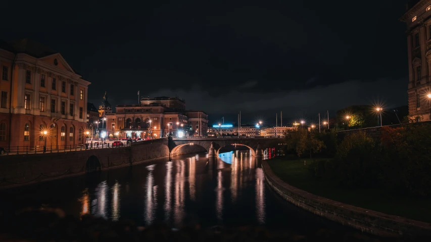 this is a dark city street by the water