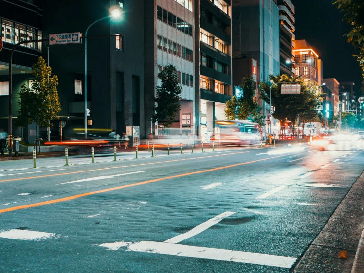 city street with lights on in the rain at night