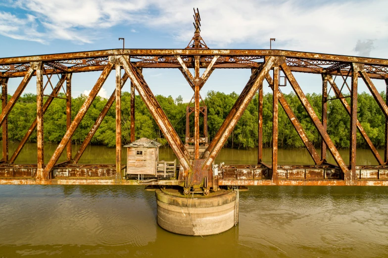 a boat passing under a bridge near water