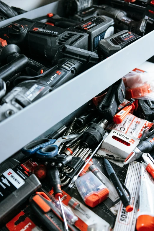 the toolbox full of tools including wrenches, drillors, wires, and other tools