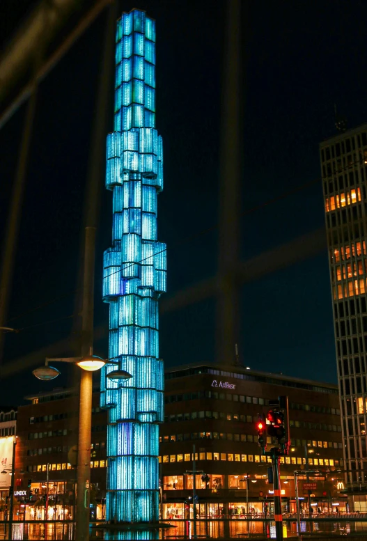 a blue tower lit up in the dark