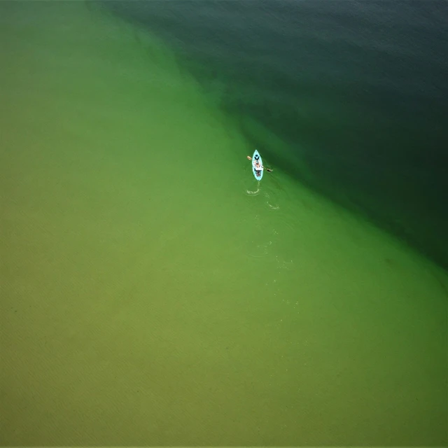 an aerial s of a boat in a deep body of water
