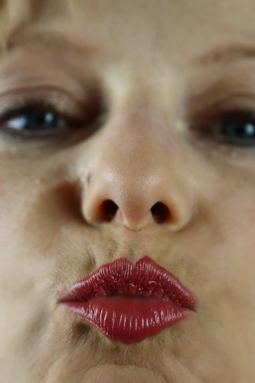 a woman has red lipstick on her lips