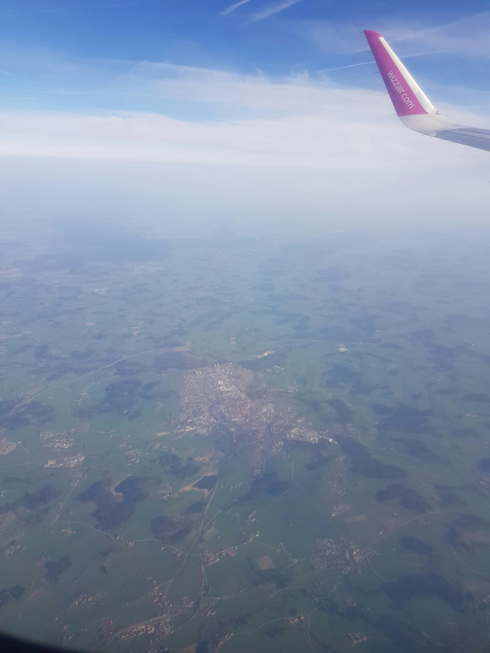 the tail end of an airplane is seen from the window