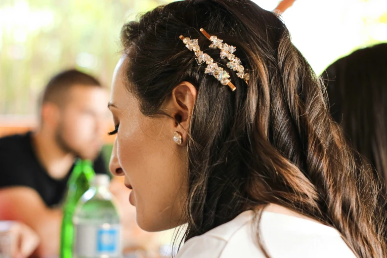 a woman with a white shirt and hair accessory on