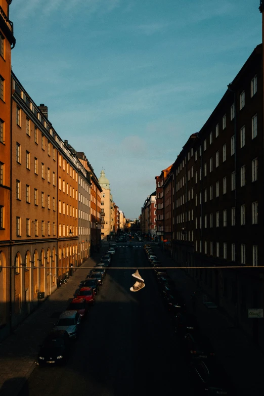 the view of some buildings across a street from an apartment building