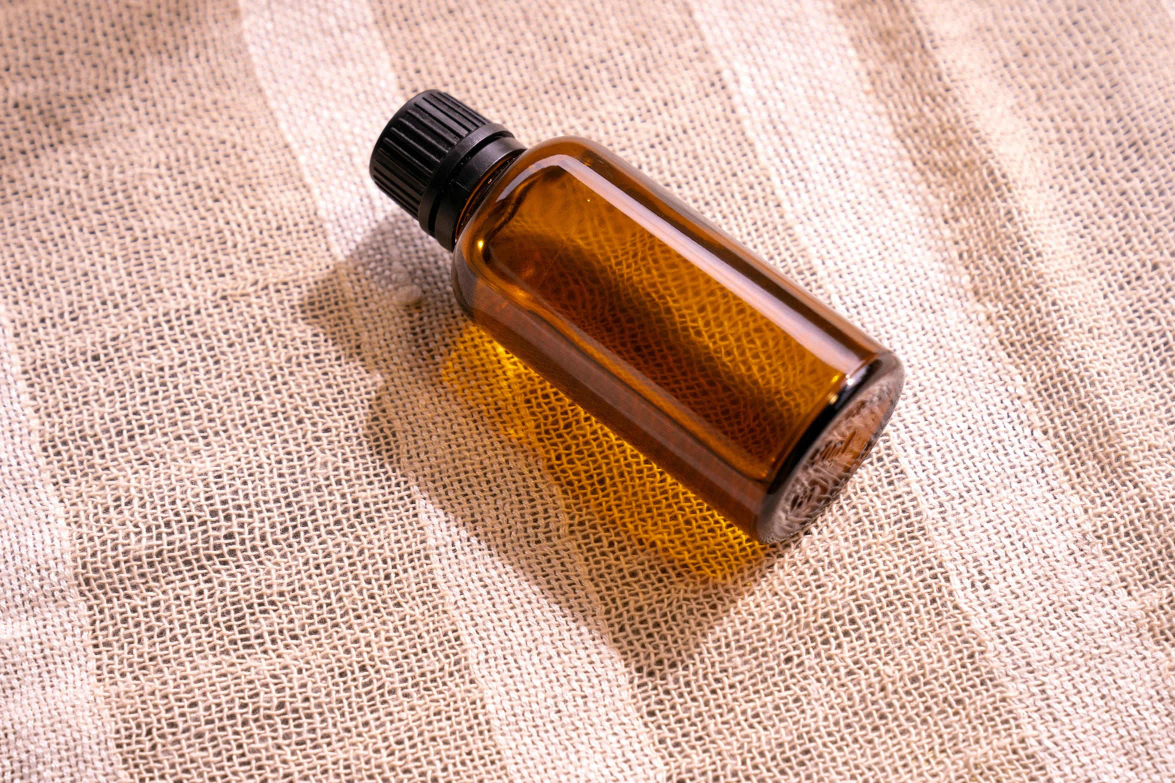 a bottle of perfume sitting on top of a brown bag