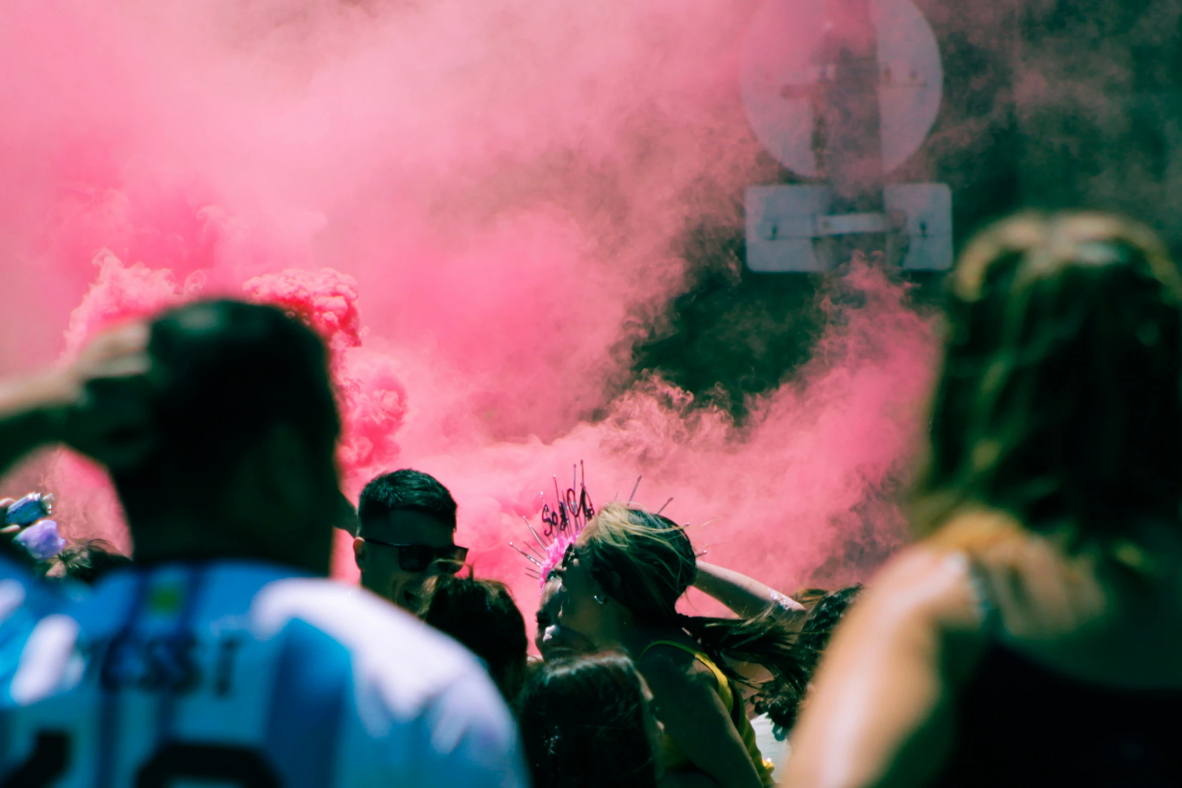 some people and pink powder in a crowd