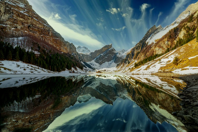 a mountain lake in a mountainous area with trees in the background