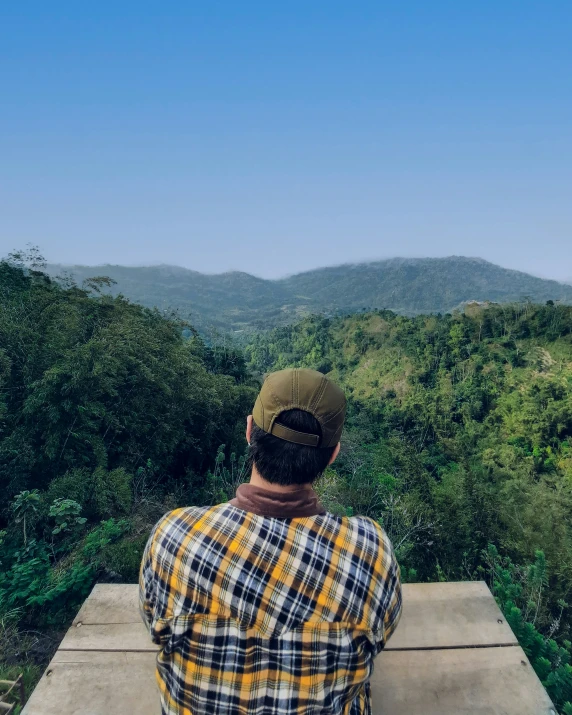 a person that is sitting on a ledge