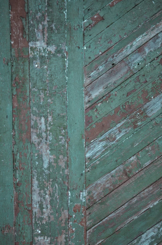 there is an old green wall with rust stains