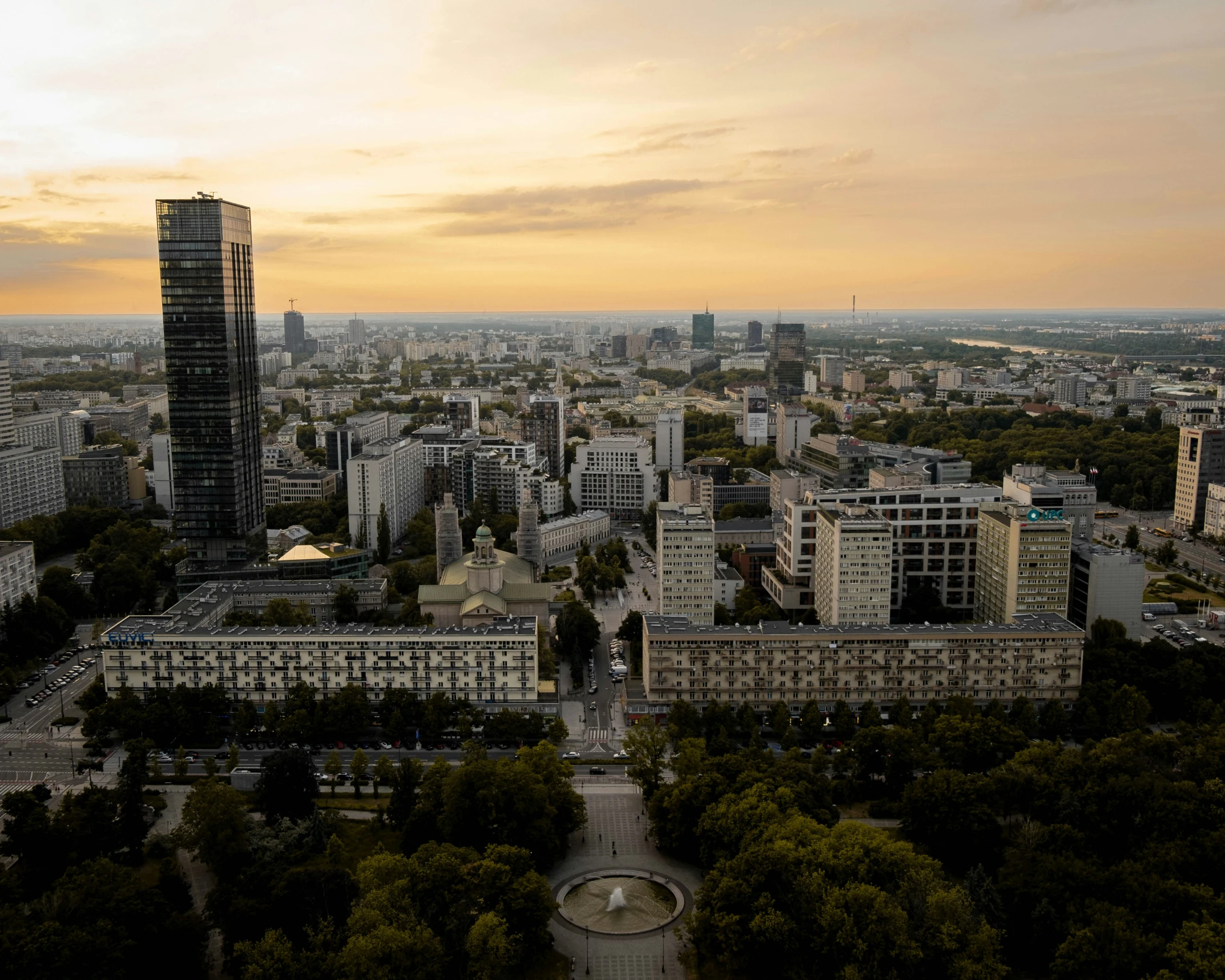 an aerial view of a city with trees and buildings