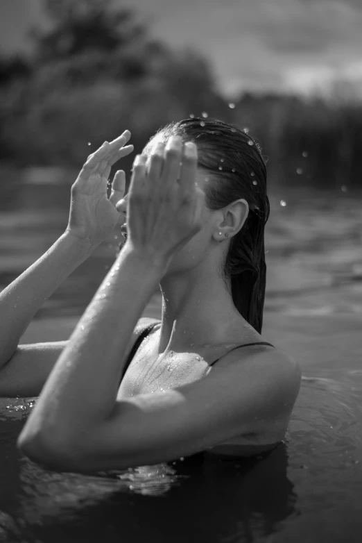 a woman is sitting in the water in the water