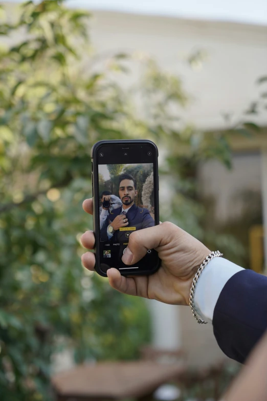 a person taking a selfie with his cellphone