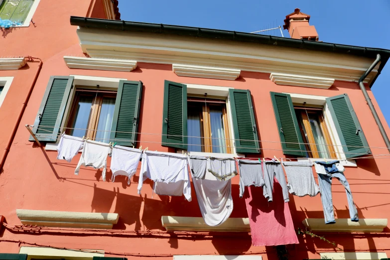 clothes hangs on a line near a building