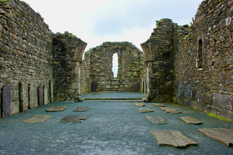 an old stone building in front of a sky