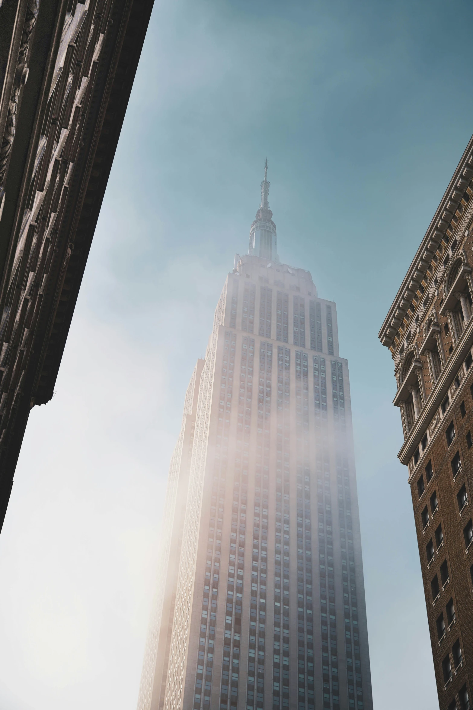 a tall skyscr rises above the surrounding buildings