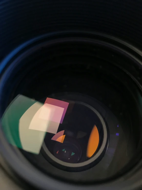 a lens with a multicolored reflection of a man