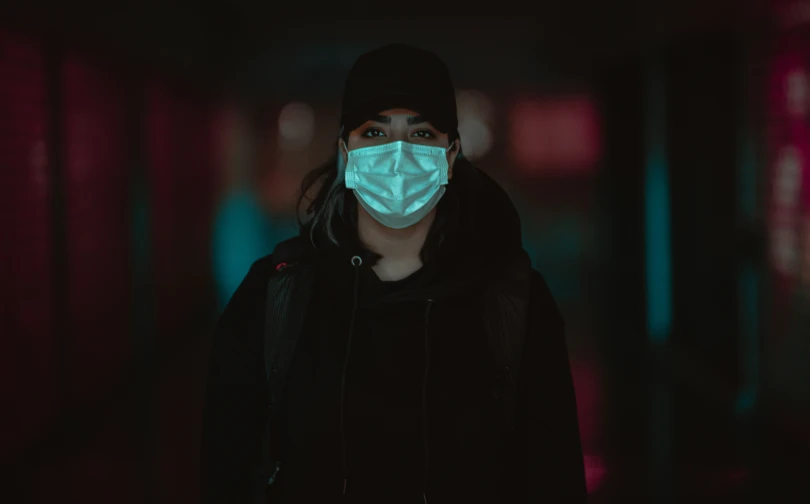 a  is wearing a mask in a dark room