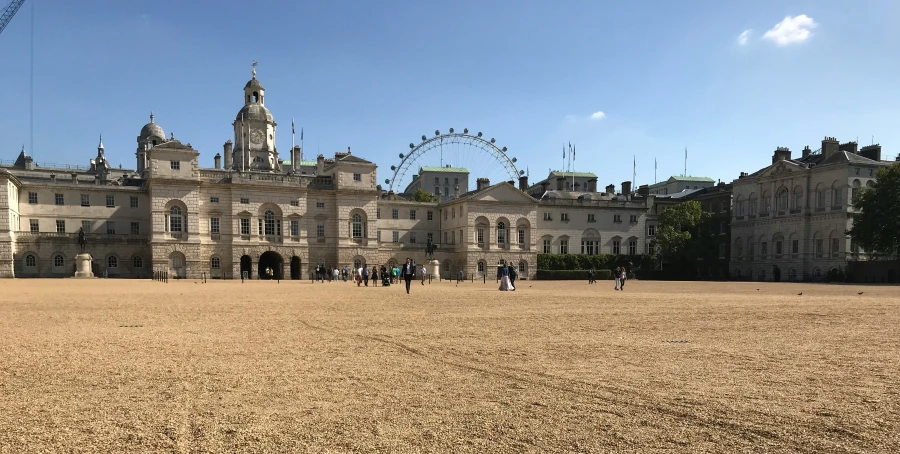 people walking around the outside of a large building