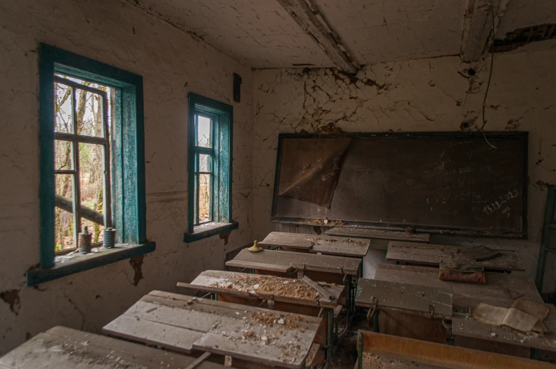 the room with dirty floors and windows is in the process of being renovated