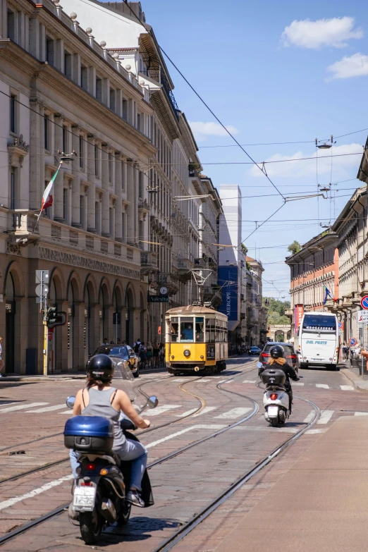 a motorcyclist drives down the city street in traffic