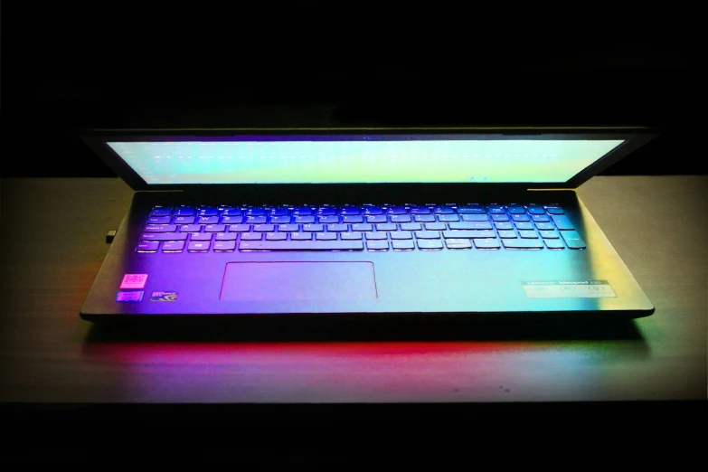 the glow laptop keyboard sits on a desk