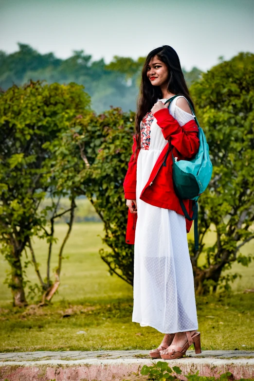 a girl is wearing a red and white dress