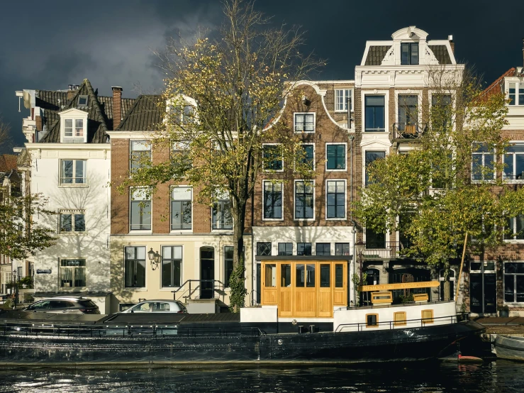 a black boat in front of several large buildings