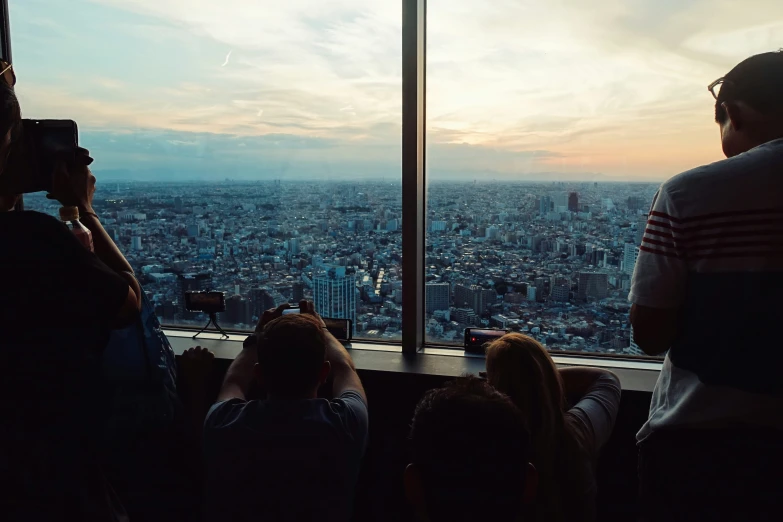 people in front of a window are standing on the edge