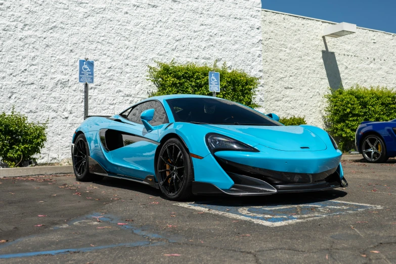 the blue car is parked next to a building