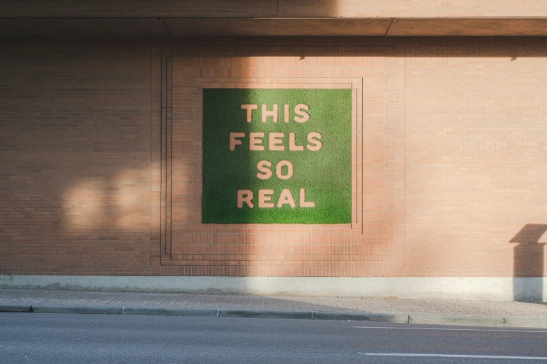 a large brick wall with a sign and the words'this fields so real '