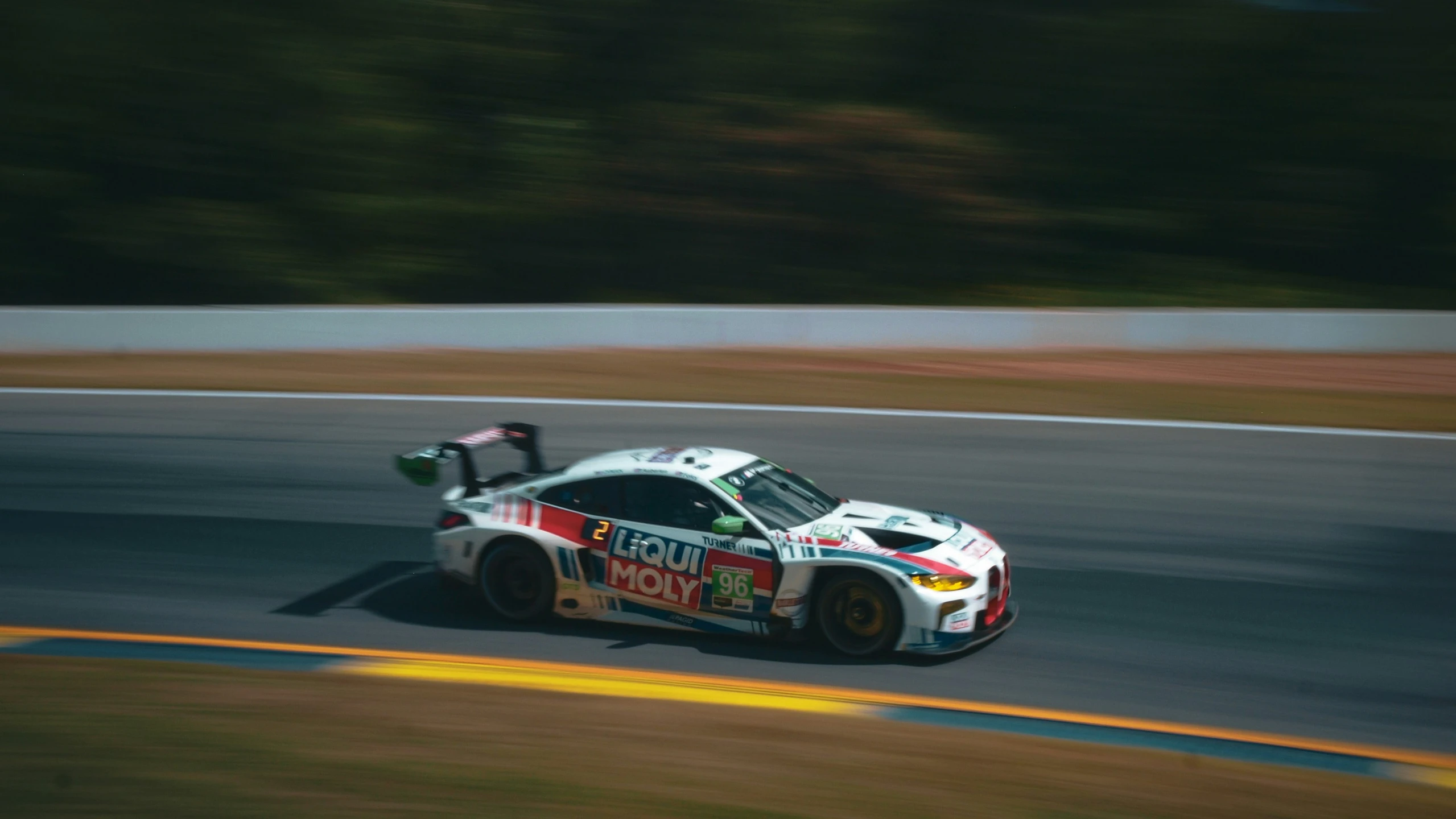 a man driving a racing car down the track