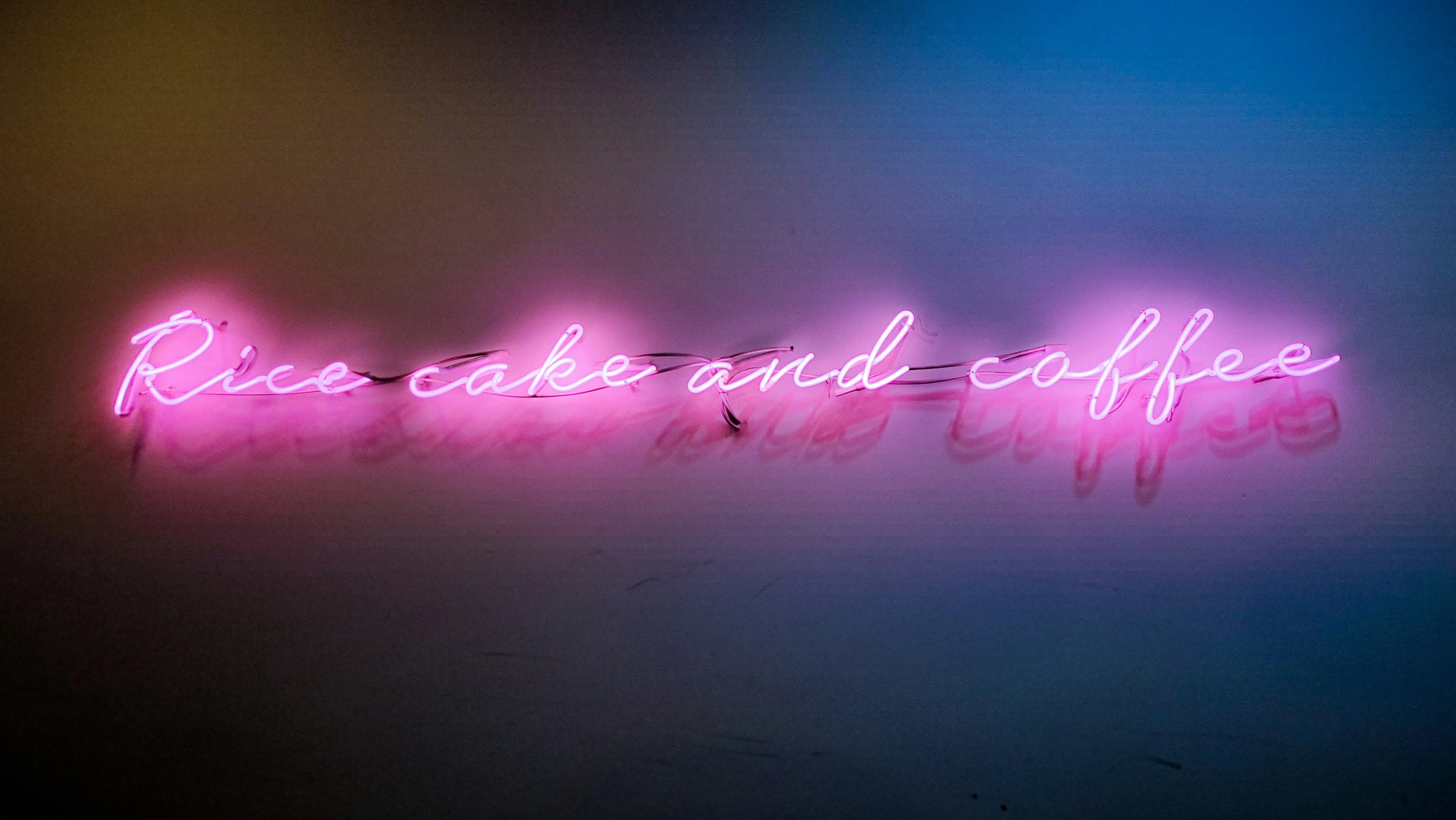 the words roses and coffee are lit up in a neon sign