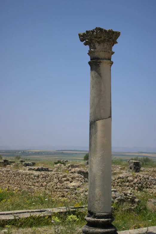 the tall column stands in front of an empty field