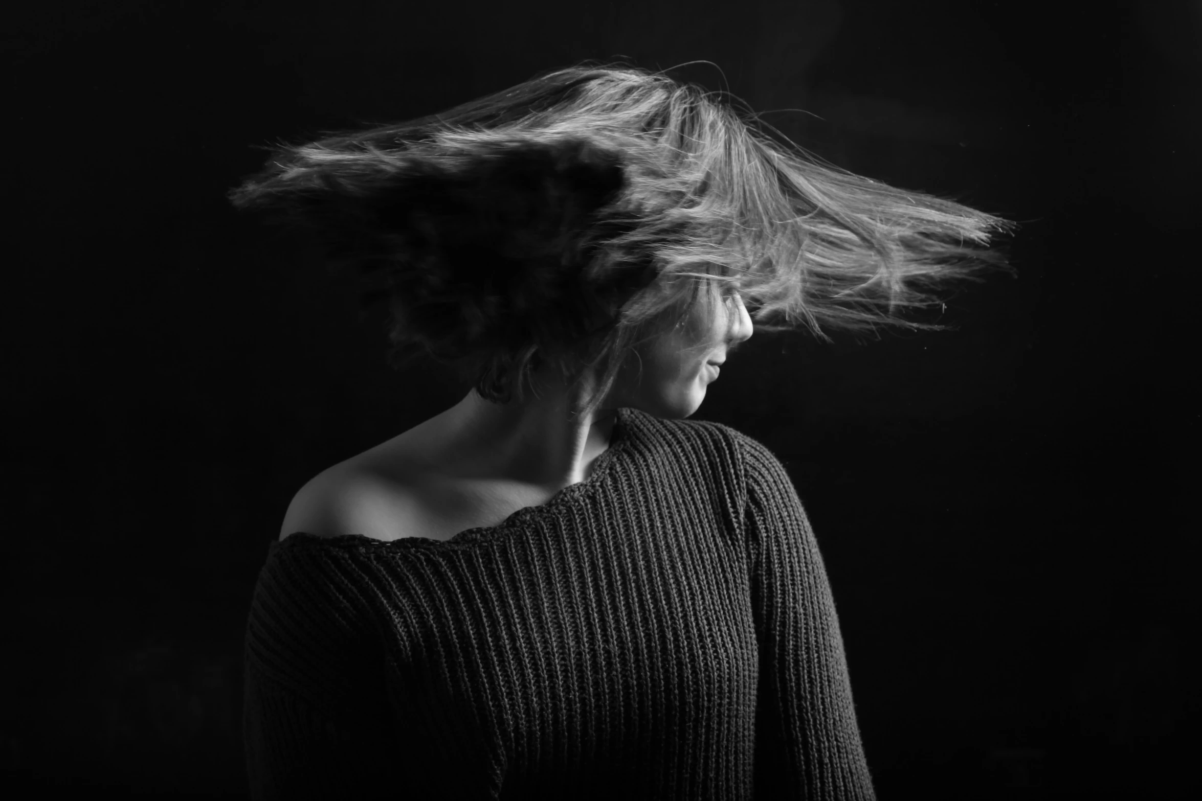 a woman with long hair blowing in the air