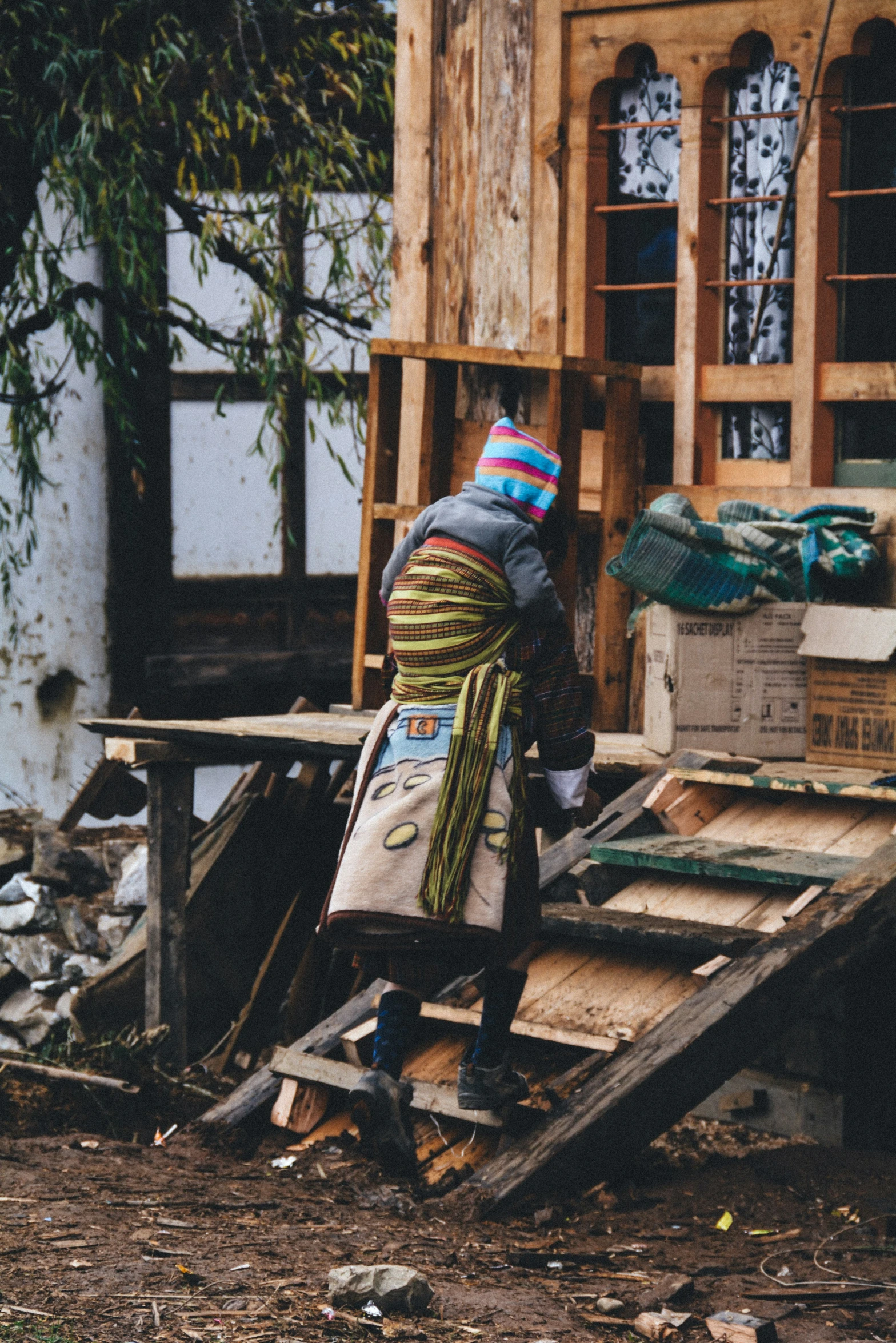 woman standing on a broken down building outside