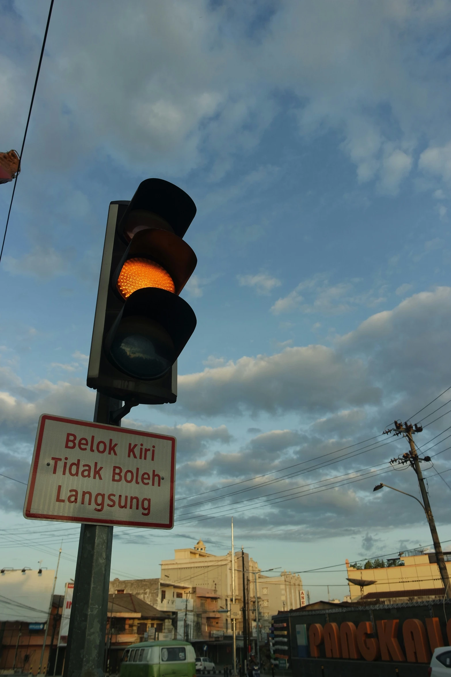 a traffic light on a street corner with a sign indicating a traffic signal