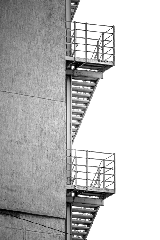 a close up of two metal stairs near a building