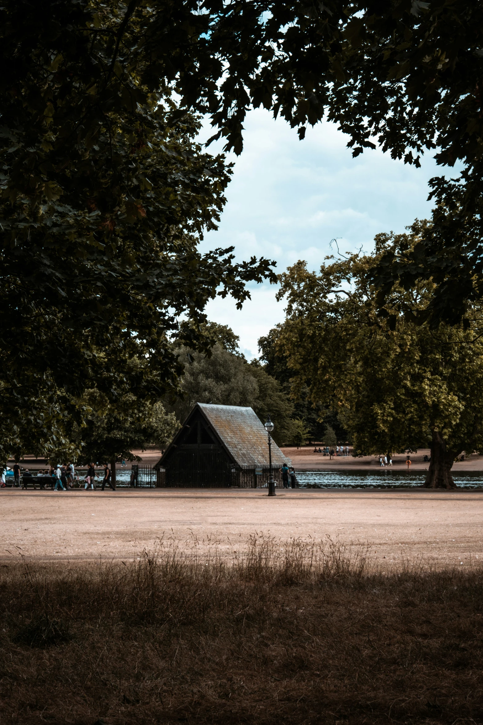 a house is sitting in a field between two trees