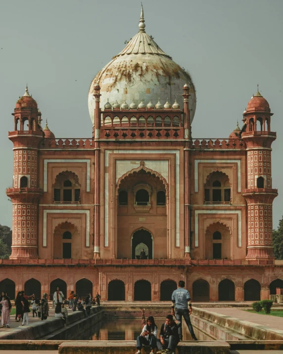 a beautiful building with people in front and across the entrance