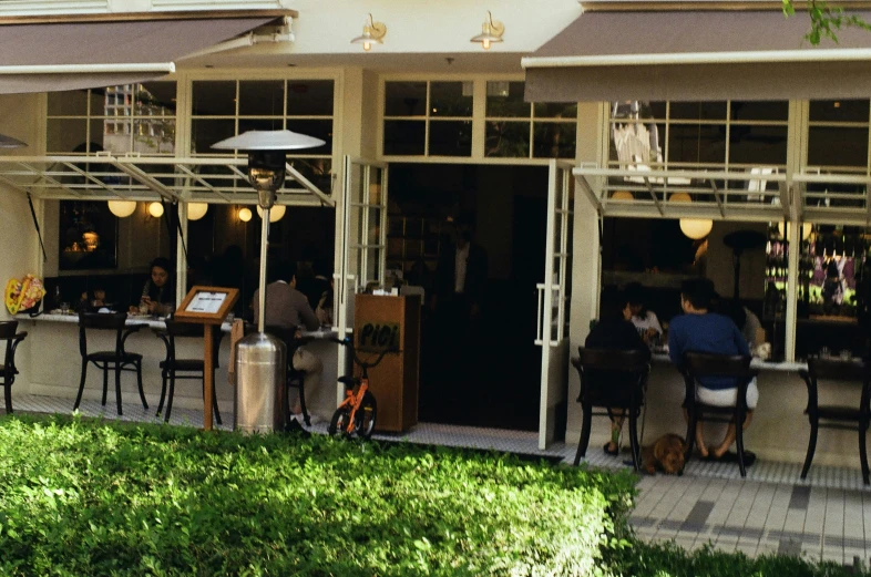 the outside of a restaurant with tables and chairs