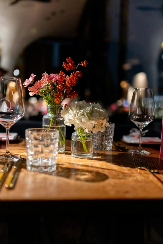 some flowers and glasses on a table