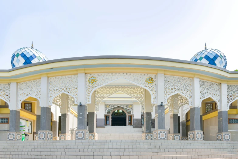 a large building with white and yellow architecture