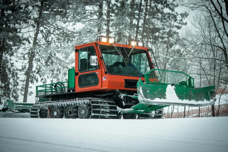 a tractor plowing snow while it's wintery