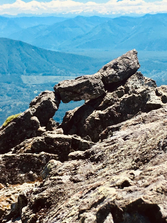 a hiker trekking up the mountains with his gear