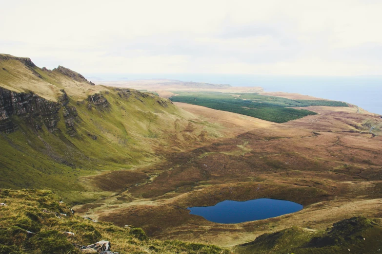 some mountains and small blue lake in the middle