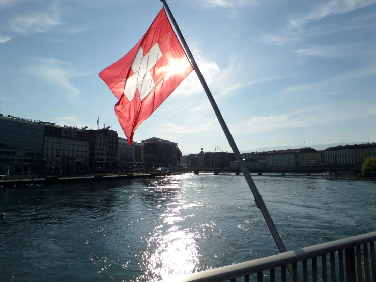 the flag is waving in front of the river